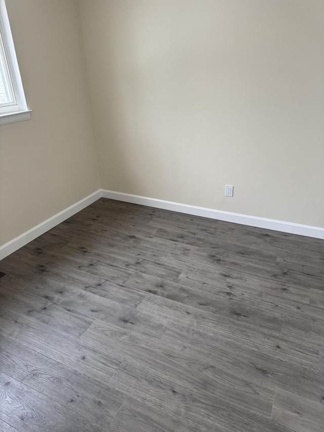 unfurnished room with hardwood / wood-style flooring