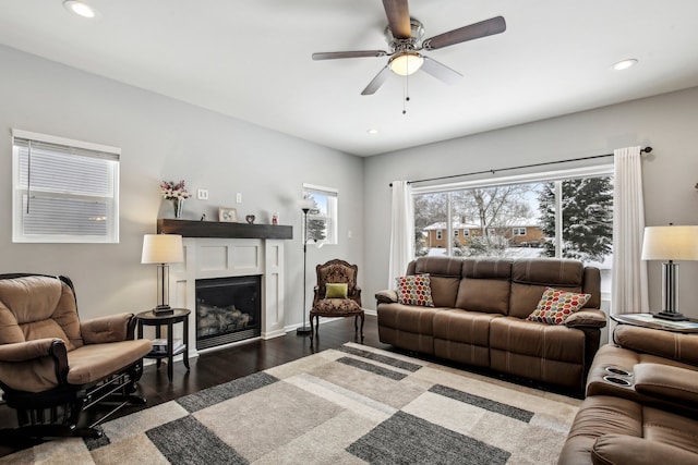 living room featuring dark hardwood / wood-style flooring and ceiling fan