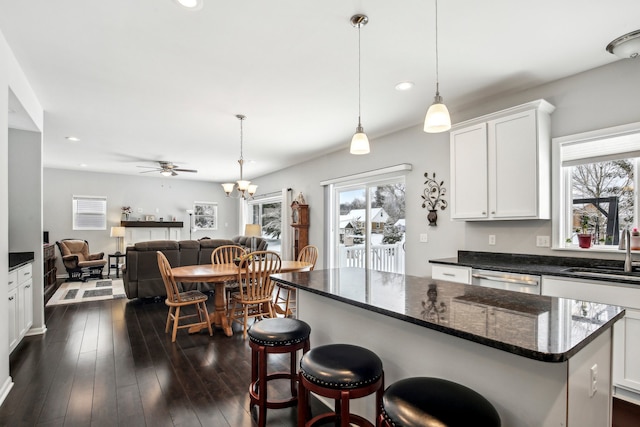 kitchen featuring plenty of natural light, dark hardwood / wood-style flooring, sink, and white cabinets