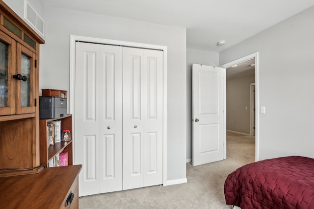 bedroom with a closet and light carpet