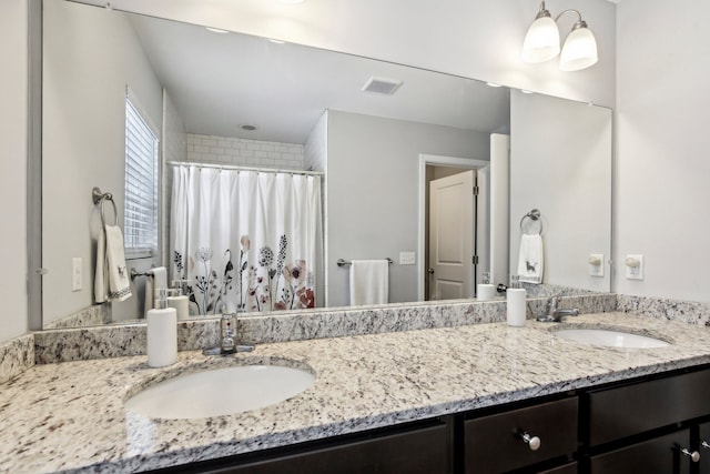 bathroom featuring vanity and curtained shower