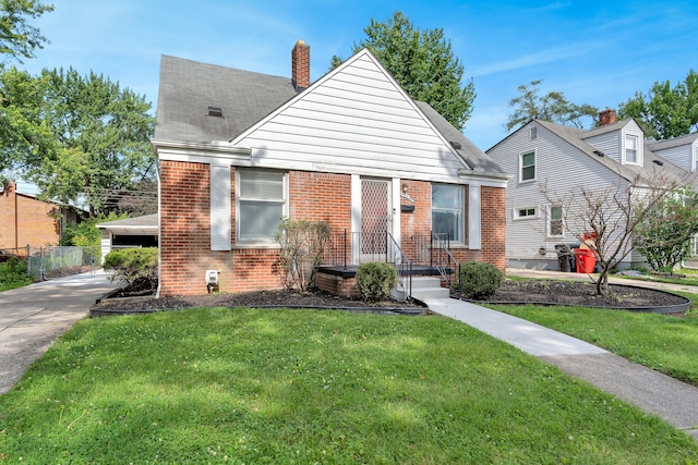 bungalow-style home with a front yard