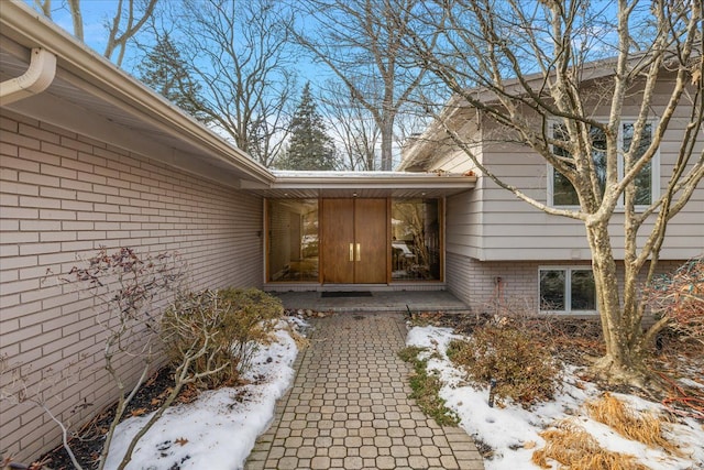 view of snow covered property entrance