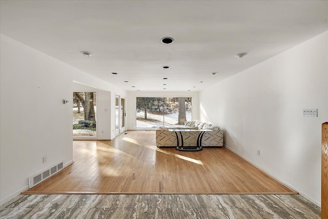 unfurnished living room featuring light wood-type flooring