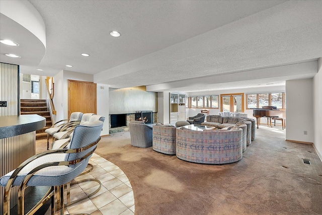 carpeted living room with a textured ceiling