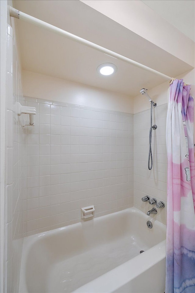 bathroom with shower / tub combo with curtain