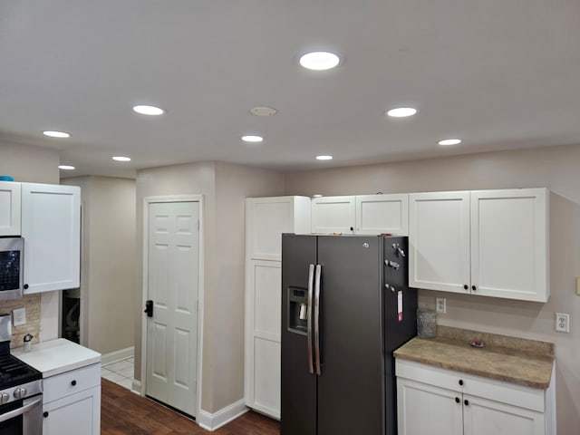 kitchen featuring appliances with stainless steel finishes and white cabinets