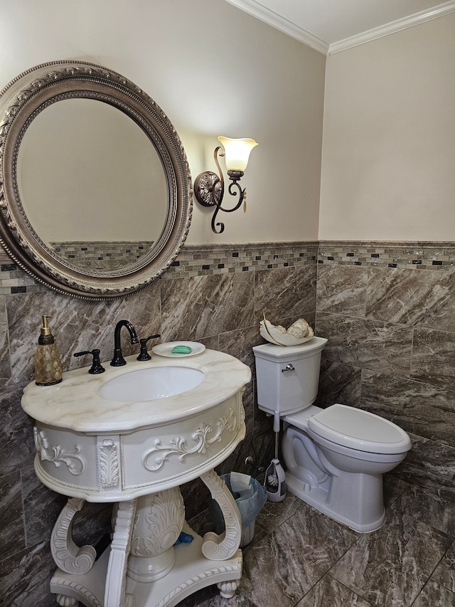 bathroom with crown molding, tile walls, and toilet