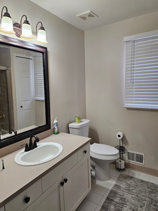 bathroom with vanity, a shower, tile patterned floors, and toilet