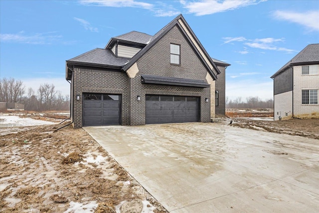 snow covered property featuring a garage