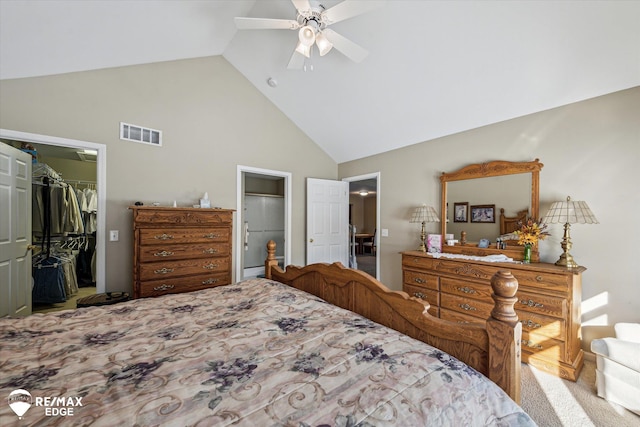 bedroom featuring a spacious closet, light colored carpet, high vaulted ceiling, a closet, and ceiling fan