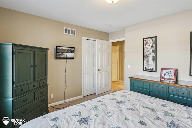 bedroom featuring light colored carpet and a closet