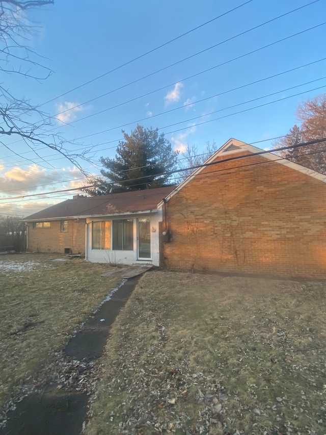 rear view of house featuring a lawn