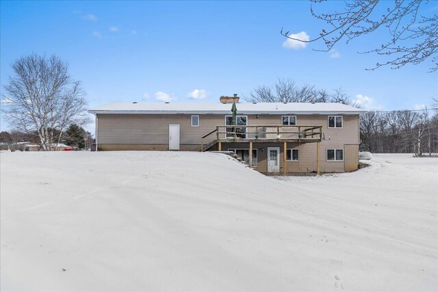 snow covered property featuring a deck