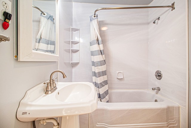 full bathroom featuring a sink and shower / bath combination with curtain