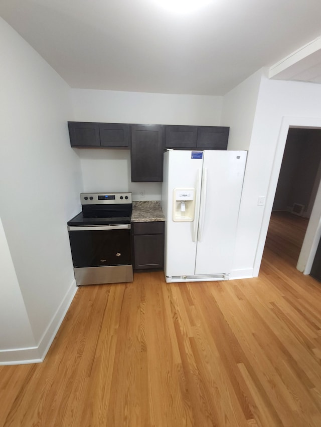 kitchen featuring light hardwood / wood-style floors, stainless steel range with electric cooktop, and white fridge with ice dispenser