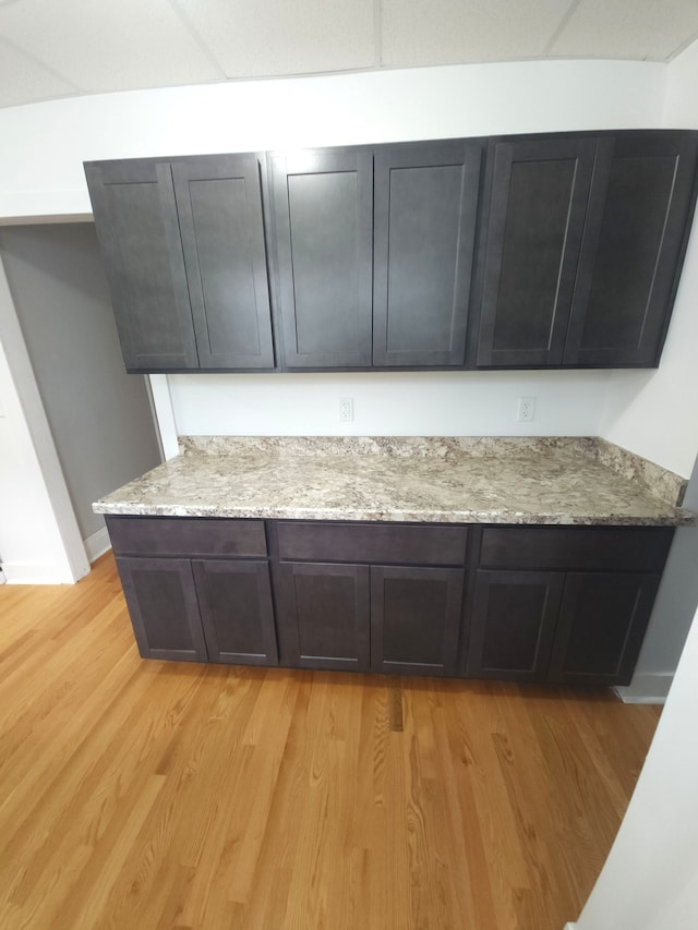 kitchen featuring light stone counters and light hardwood / wood-style flooring