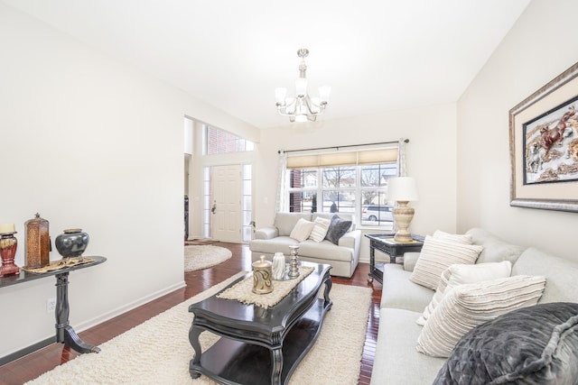 living room featuring dark wood-type flooring and a chandelier