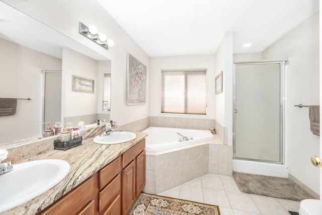 bathroom featuring vanity, plus walk in shower, and tile patterned flooring