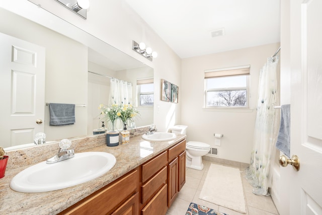 bathroom featuring tile patterned floors, toilet, and vanity