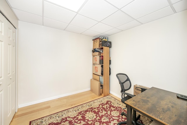 office featuring hardwood / wood-style flooring and a paneled ceiling