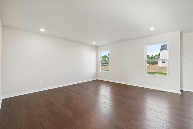 spare room with dark wood-type flooring