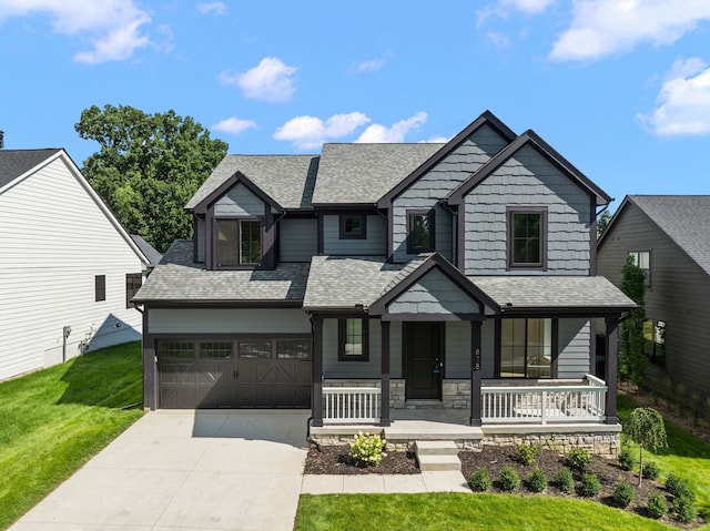 craftsman house featuring a garage, a front lawn, and a porch