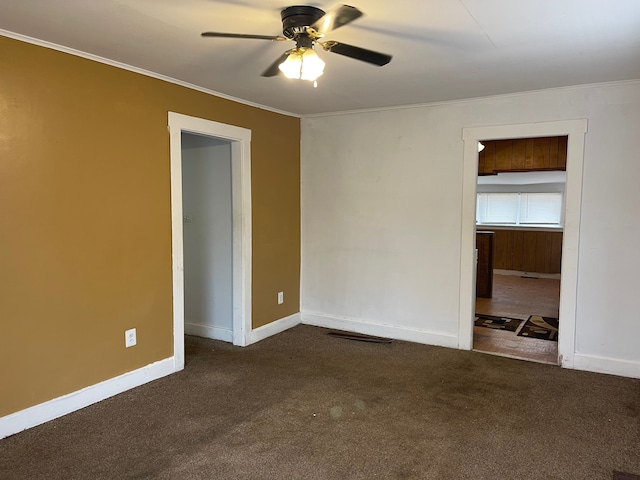 carpeted empty room featuring ceiling fan and ornamental molding