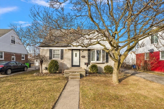 bungalow-style house with a front lawn