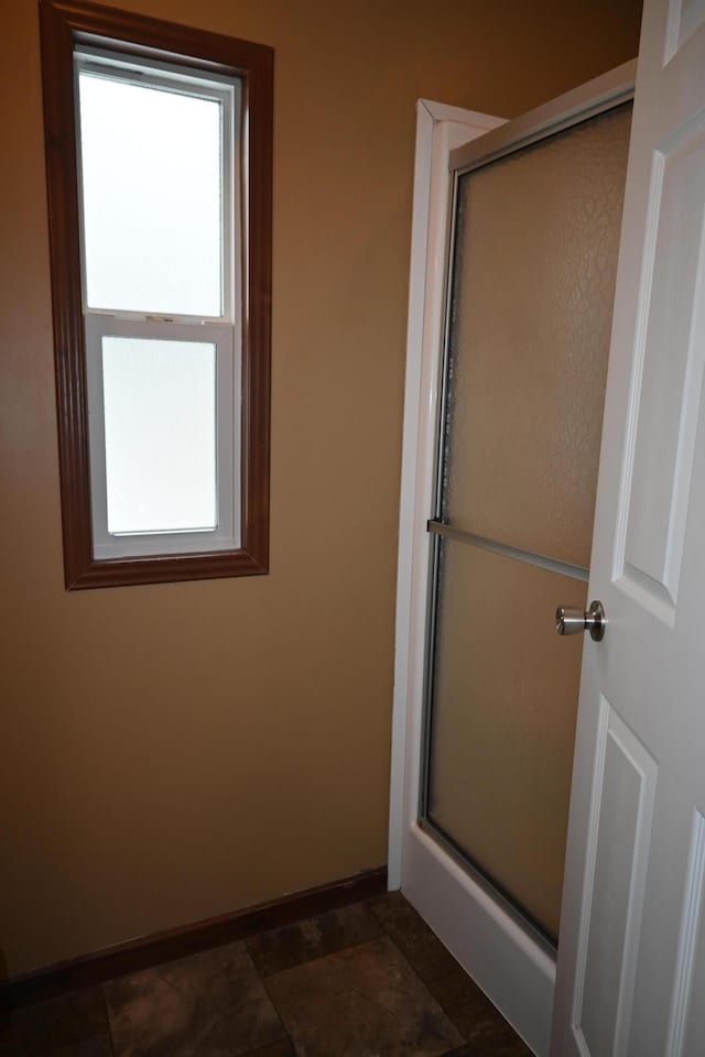 bathroom featuring a shower with shower door