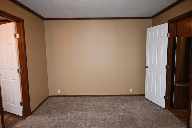 unfurnished room with crown molding, a textured ceiling, and dark carpet