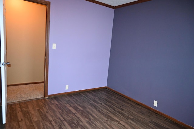 unfurnished room with crown molding and dark hardwood / wood-style floors