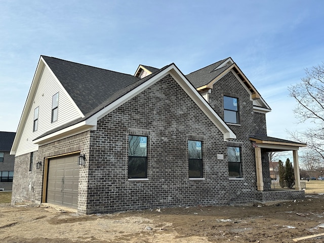 view of side of property with a garage