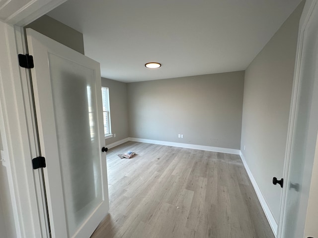 unfurnished room with light wood-type flooring