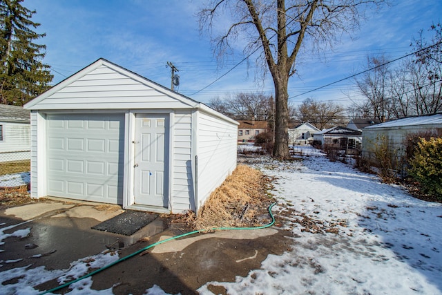 snow covered structure with a garage