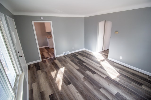 spare room with dark wood-type flooring