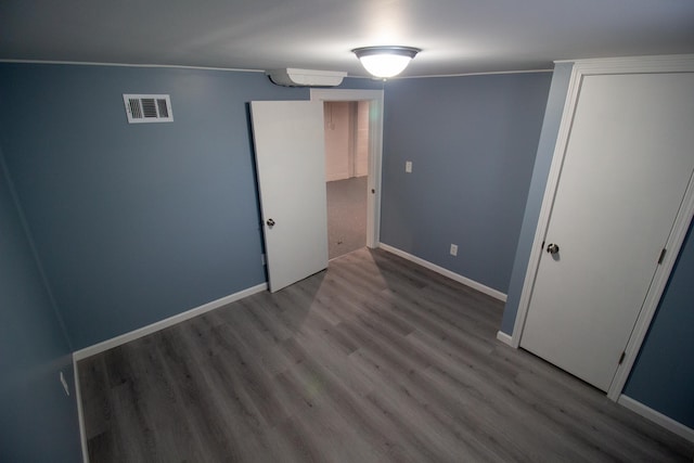 unfurnished bedroom with a closet and light wood-type flooring