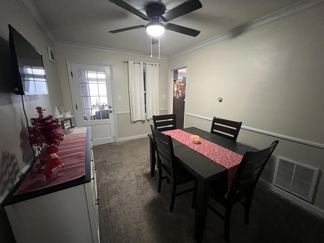 carpeted dining area featuring crown molding and ceiling fan