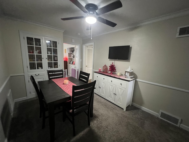 dining space with ornamental molding, carpet, and ceiling fan