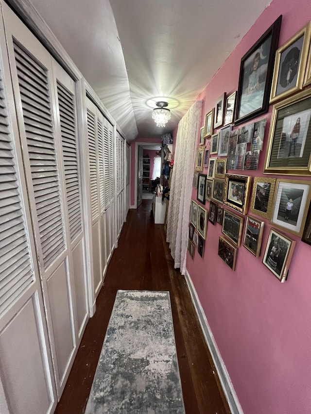 corridor featuring dark wood-type flooring