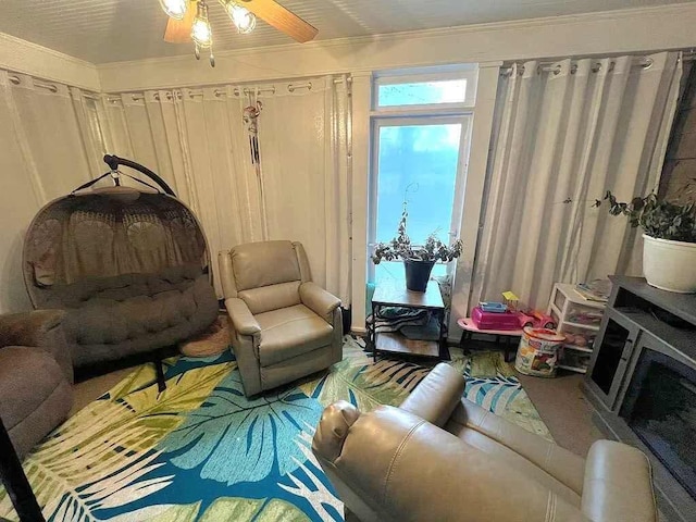 living room with crown molding and ceiling fan