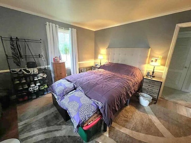 bedroom with hardwood / wood-style floors and crown molding