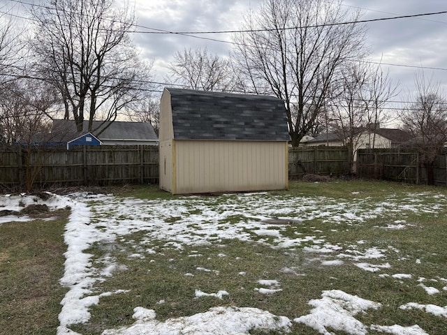 snowy yard with a shed