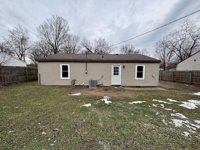 rear view of house featuring a yard and central AC