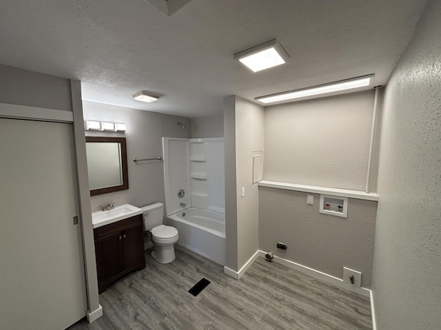 full bathroom with vanity, hardwood / wood-style flooring, bathtub / shower combination, and toilet