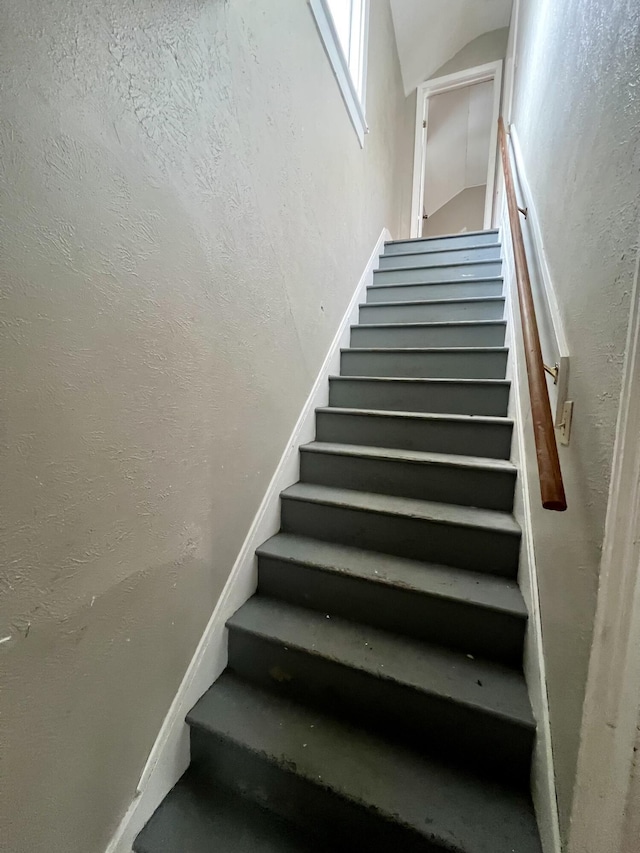 stairs featuring lofted ceiling