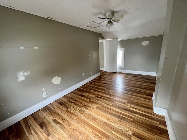 unfurnished room featuring wood-type flooring, vaulted ceiling, and ceiling fan