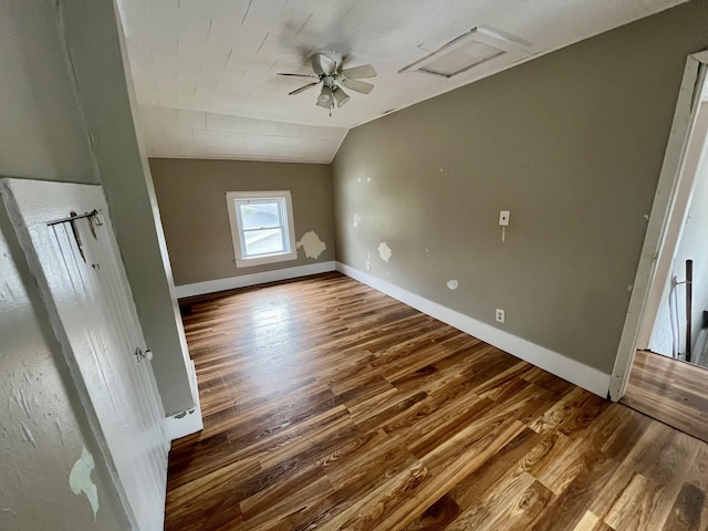 interior space with lofted ceiling, dark wood-type flooring, and ceiling fan