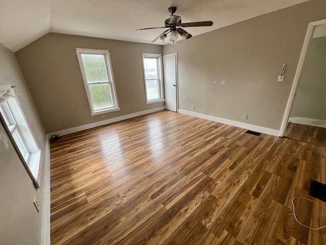 interior space with lofted ceiling, hardwood / wood-style floors, and ceiling fan