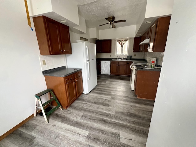 kitchen featuring white appliances, light hardwood / wood-style flooring, a textured ceiling, ceiling fan, and backsplash